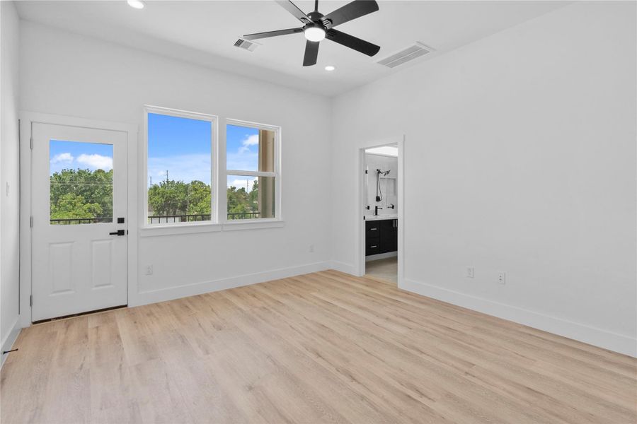 Spacious primary suite with abundant natural light, private balcony access, and a sleek en-suite bathroom. Spacious primary suite with abundant natural light, private balcony access, and a sleek en-suite bathroom.
