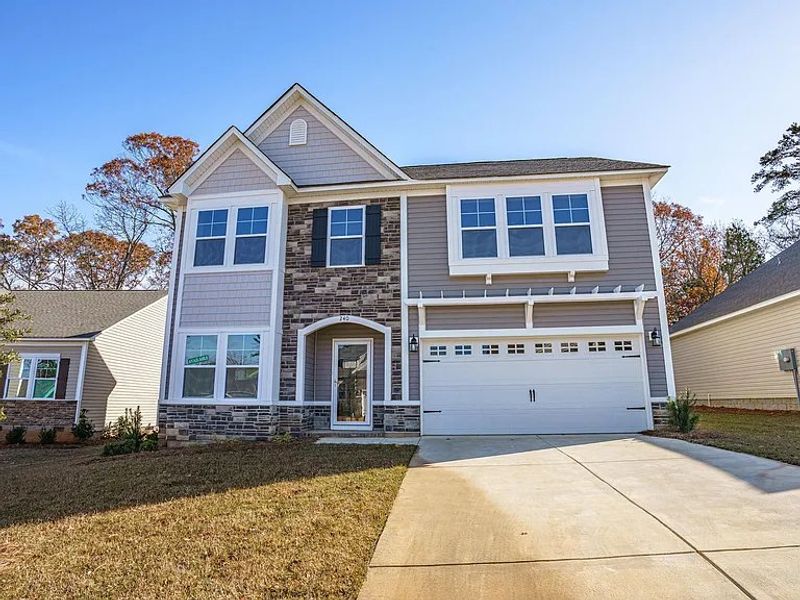 Front exterior of a new home in Providence Station at Trolley Run, Aiken, SC, highlighting curb appeal (Image 1).