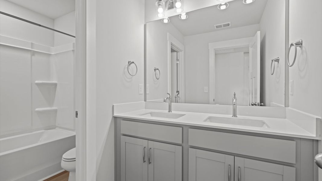 Vibrant and welcoming bathroom with elegant countertop space and polished details