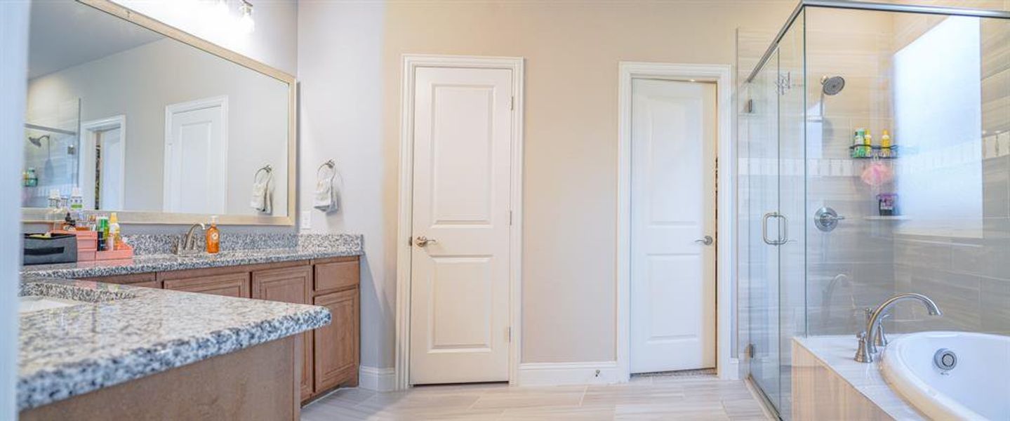 Full bathroom with a bath, vanity, a stall shower, and wood finish floors