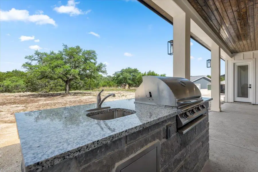 View of patio featuring a sink, exterior kitchen, and area for grilling View of patio featuring a sink, exterior kitchen, and area for grilling