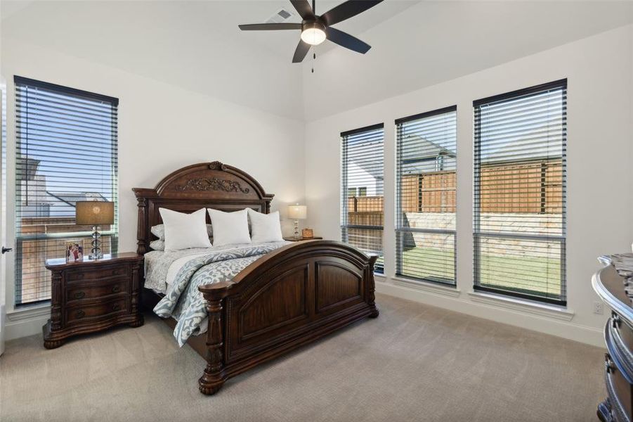 Bedroom featuring light carpet and ceiling fan