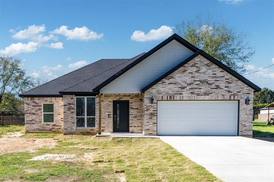 View of front of property featuring a garage