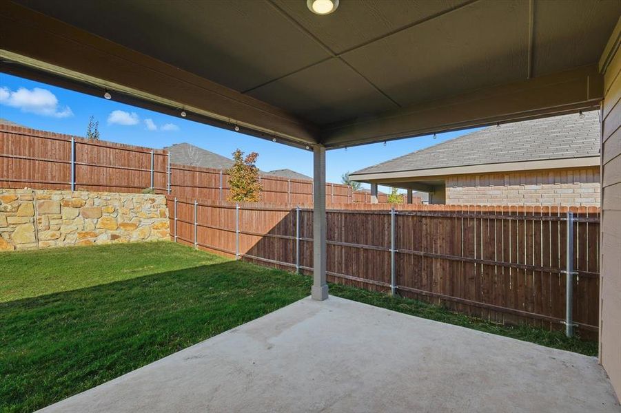 Fenced backyard featuring a covered patio area Fenced backyard featuring a covered patio area