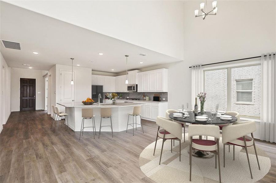 Dining space featuring hardwood / wood-style flooring, sink, and an inviting chandelier