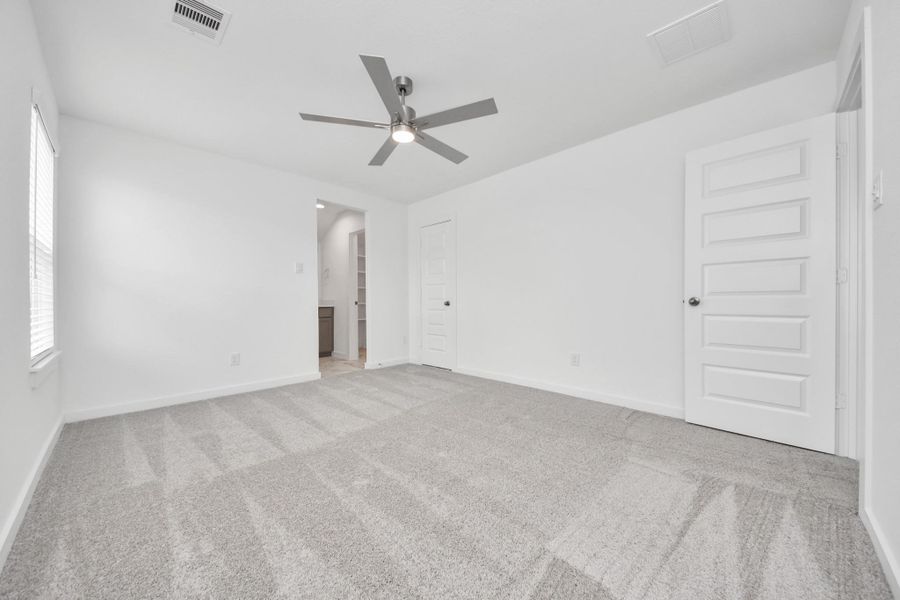 Generously sized secondary bedrooms featuring spacious closets, soft and inviting carpeting underfoot, large windows allowing plenty of natural light, and the added touch of privacy blinds for your personal retreat. Sample photo of completed home with similar floor plan. Actual colors and selections may vary.