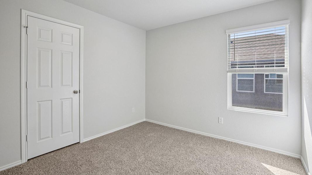 An inviting atmosphere is created by neutral tones and plush carpeting in this comfortable bedroom. An inviting atmosphere is created by neutral tones and plush carpeting in this comfortable bedroom.