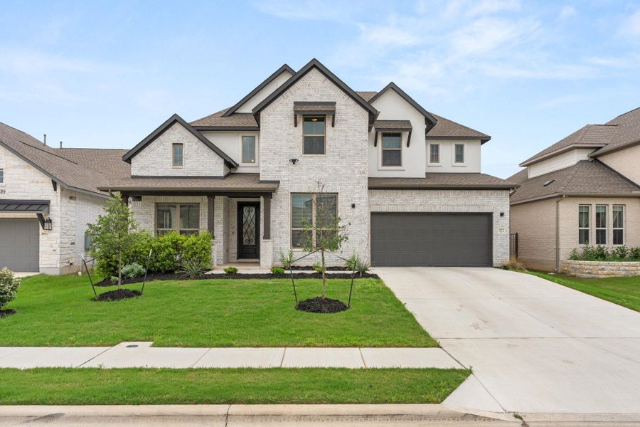 A striking modern facade with contrasting brick and siding accents awaits your personal touch. A striking modern facade with contrasting brick and siding accents awaits your personal touch.
