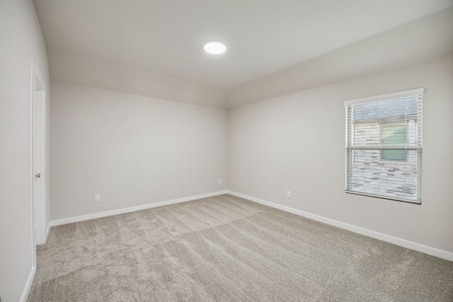 Bedroom in the Wimbledon home plan by Trophy Signature Homes – REPRESENTATIVE PHOTO