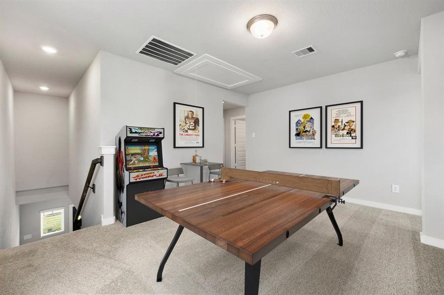 Perfect for entertaining is this amazing game room! Right upstairs this space would be a fabulous teen hangout, media room, or adult game room complete with pool table and big screen TVs. Featuring plush carpet, high ceilings, neutral paint and large windows.