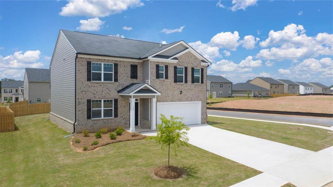 Front exterior of a new home in The Reserve at Calcutta, Stockbridge, GA, highlighting curb appeal (Image 23).