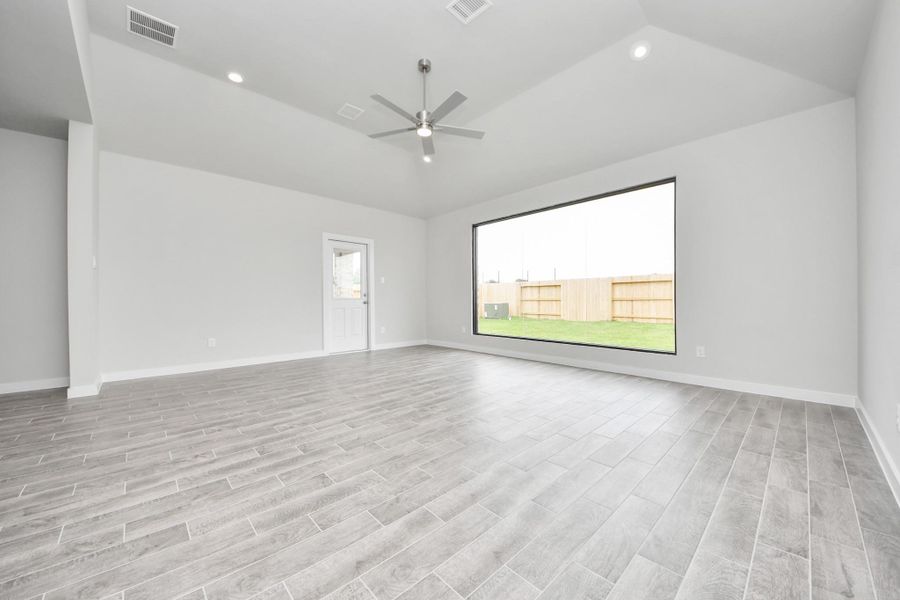 Take another glimpse into the heart of the home with this additional view of the family room—a sprawling space ready to accommodate all your gatherings. Sample photo of completed home with similar floor plan. Actual colors and selections may vary.