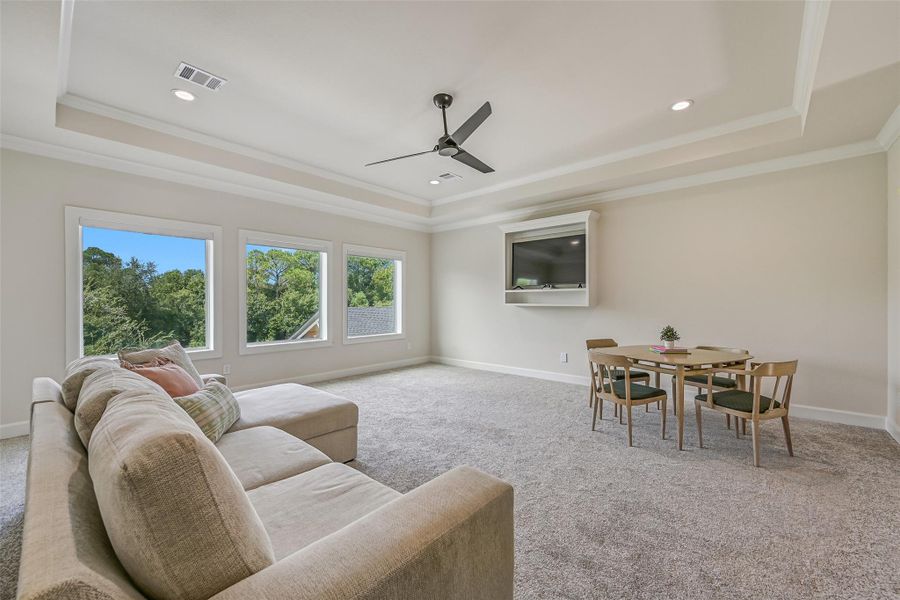 Another view emphasizes the impressive scale of the gameroom, with three oversized windows providing abundant natural light, a built-in media niche and plenty of flexible space for lounging, games or entertaining.