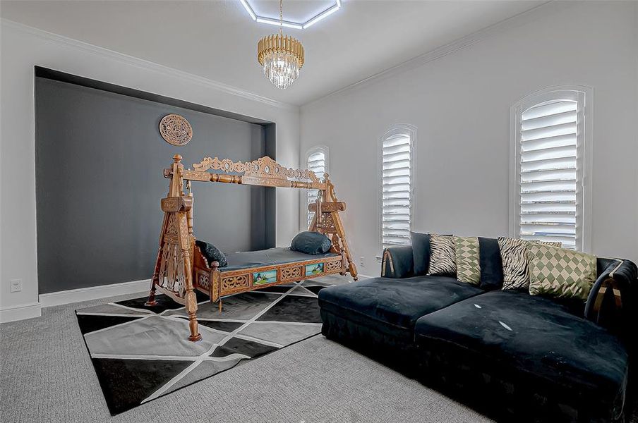 Formal Dining Room: A thoughtfully designed space with custom built-in shelving, a dazzling chandelier, and a painted accent wall. Conveniently connected to the kitchen via a butler pantry, it is perfect for hosting sophisticated dinner parties.