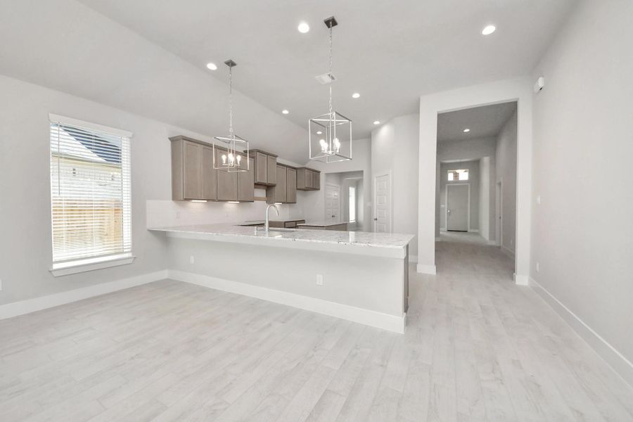 All of this overlooks your expansive family room, creating a perfect space for culinary delights and family gatherings. Sample photo of completed home with similar floor plan. Actual colors and selections may vary.