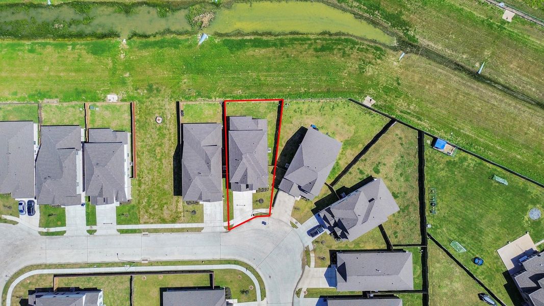 An aerial view of a spacious subdivision lot, highlighting a well-maintained yard and a fully fenced perimeter, offering both privacy and expansive outdoor space. An aerial view of a spacious subdivision lot, highlighting a well-maintained yard and a fully fenced perimeter, offering both privacy and expansive outdoor space.