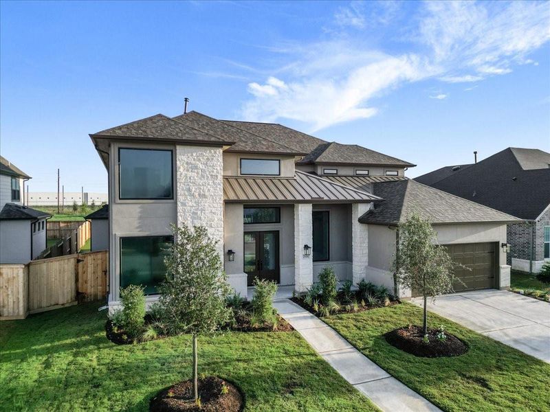 Front exterior of a new home in Jordan Ranch 70′ Lots, Fulshear, TX, highlighting curb appeal (Image 24). Front exterior of a new home in Jordan Ranch 70′ Lots, Fulshear, TX, highlighting curb appeal (Image 24).