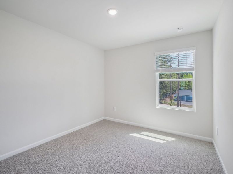 Two secondary bedrooms are ideally situated away from the primary suite.