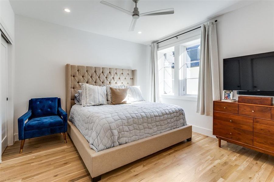 Bedroom with light wood-style flooring, a ceiling fan, recessed lighting, and a closet Bedroom with light wood-style flooring, a ceiling fan, recessed lighting, and a closet