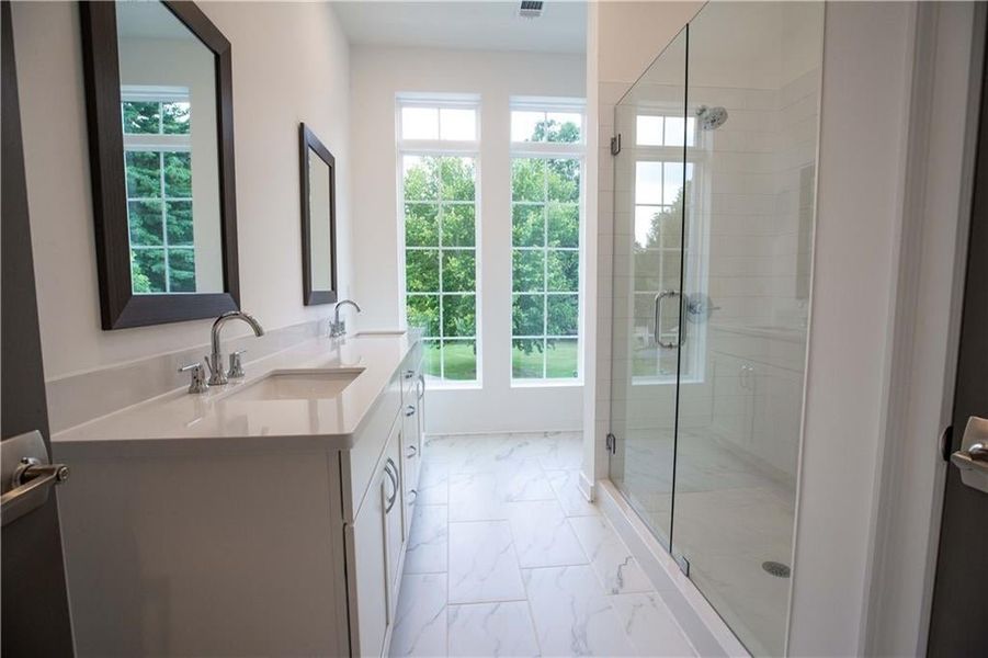 Owners Bath with frameless walk in shower door *Home is Under Construction. Photos shown are from other TPG Communities to display how the home will live*