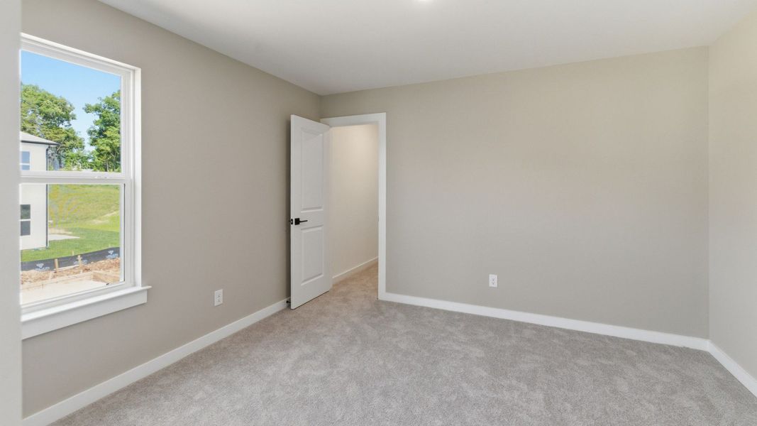 Bedroom with carpet and window