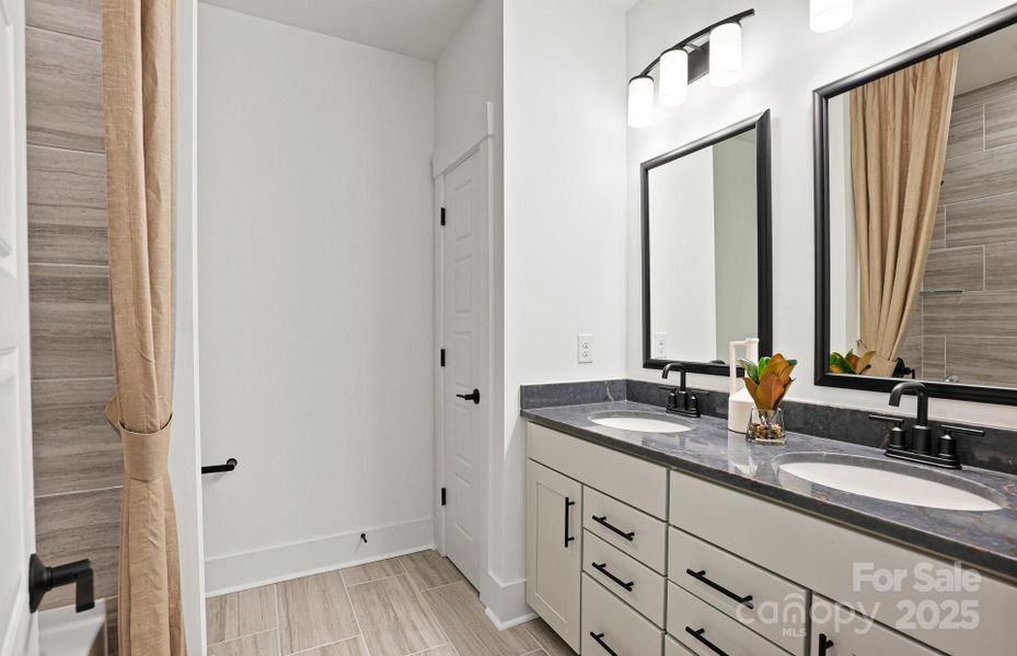 Secondary Bath with Dual Sinks and a Ton of Storage.  Representative Photo.