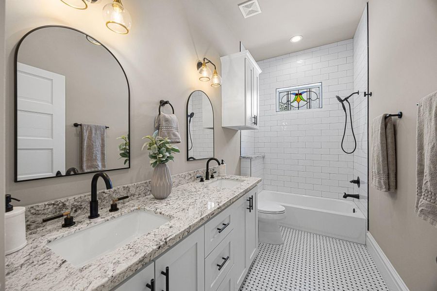 The upstairs 2nd bathroom offers a tub/shower combo, as well as a dual sink vanity with granite countertops. The upstairs 2nd bathroom offers a tub/shower combo, as well as a dual sink vanity with granite countertops.