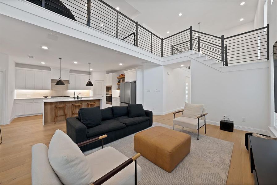 Open-concept living space with high ceilings and wood-finish flooring