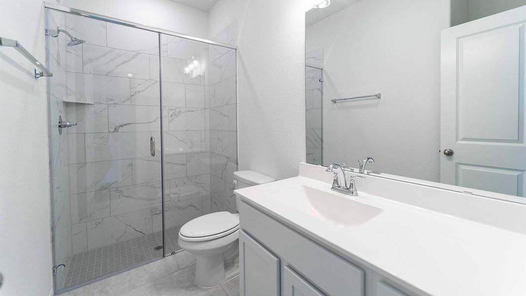 Bathroom with a marble finish shower and vanity Bathroom with a marble finish shower and vanity