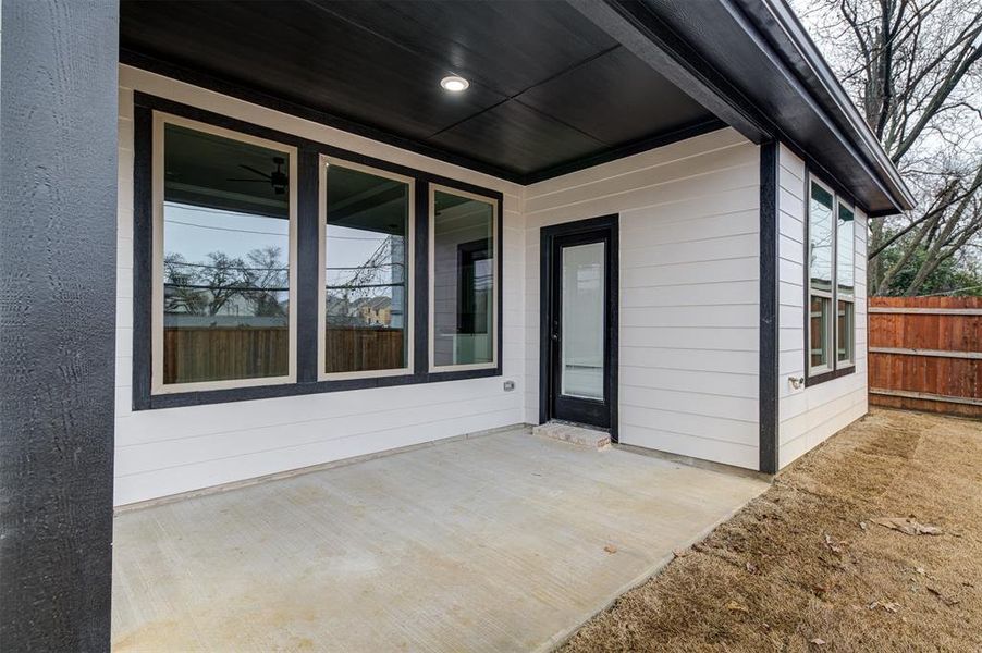 View of exterior entry with a patio