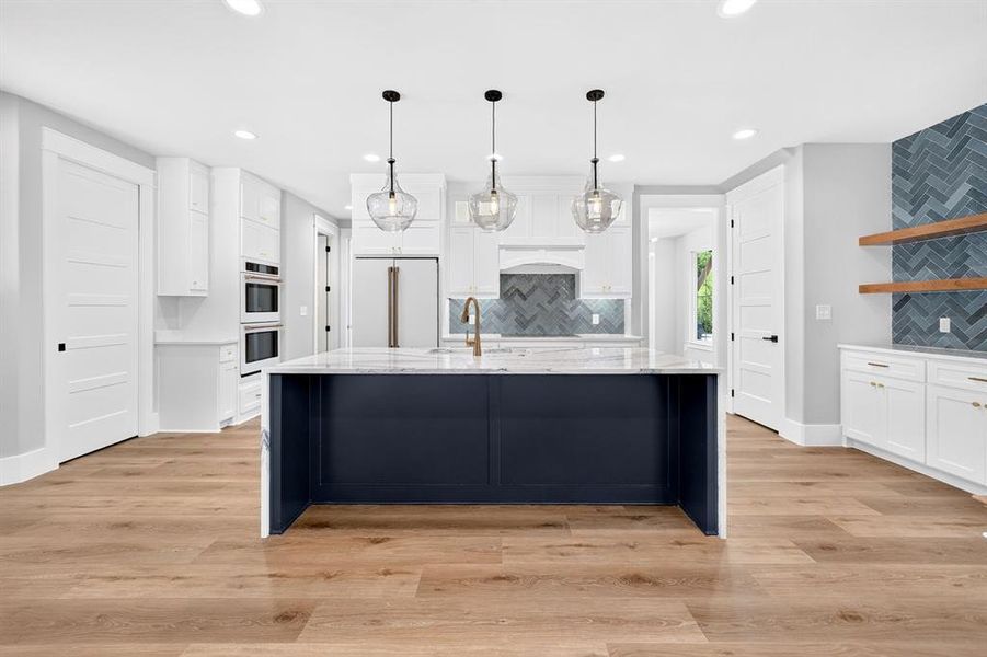 Gourmet chef's kitchen featuring a massive waterfall island with bar seating, crisp shaker cabinetry, and built-in stainless high end Cafe appliances. Gourmet chef's kitchen featuring a massive waterfall island with bar seating, crisp shaker cabinetry, and built-in stainless high end Cafe appliances.