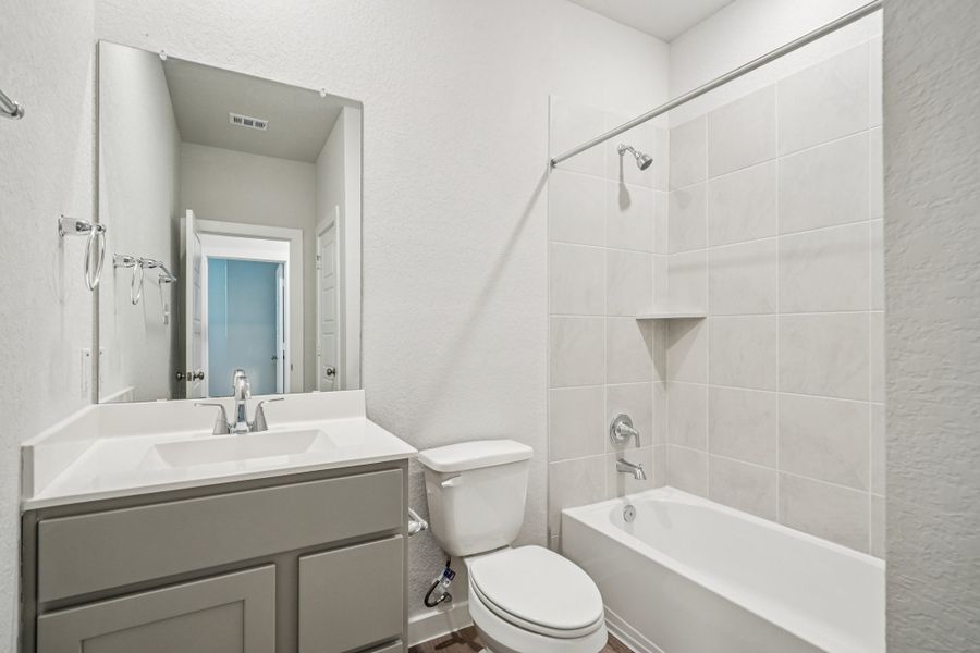 A bathroom with a toilet and sink.