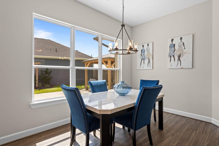 Indulge in elegance where the dining area seamlessly blends sophistication and comfort. With ample space, stunning finishes, and a warm ambiance, it provides the perfect setting for intimate dinners and festive gatherings alike. *Image depicts similar floorplan in the community.