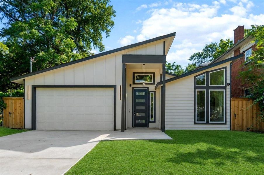 Modern architectural facade with a striking asymmetrical roofline and dark trim accents Modern architectural facade with a striking asymmetrical roofline and dark trim accents