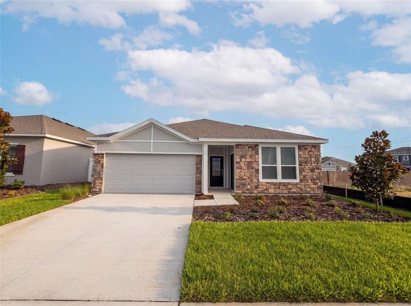 Front exterior of a new home in Hidden Ridge, Groveland, FL, highlighting curb appeal (Image 2).