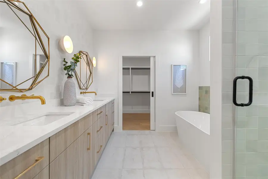 Bathroom featuring vanity, tile patterned flooring, and shower with separate bathtub