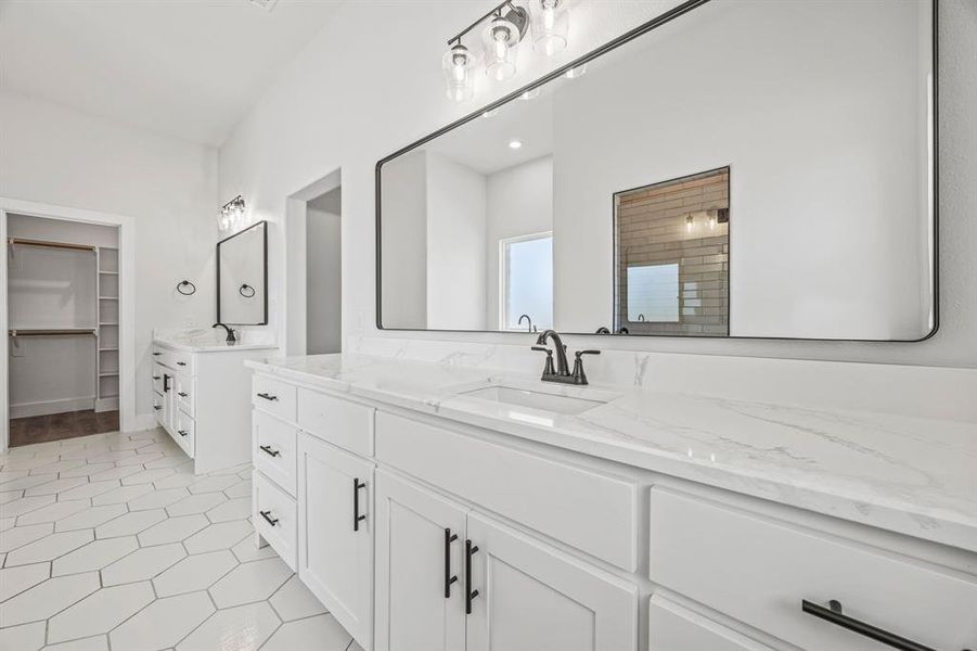 Full bath with two vanities, a tile shower, and a spacious closet Full bath with two vanities, a tile shower, and a spacious closet