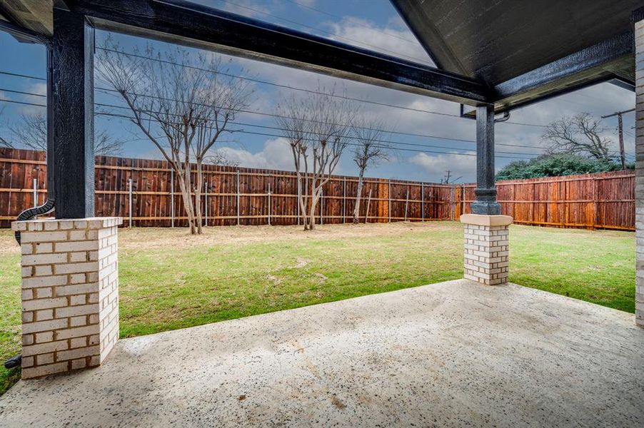 View of yard featuring a fenced backyard and a patio area