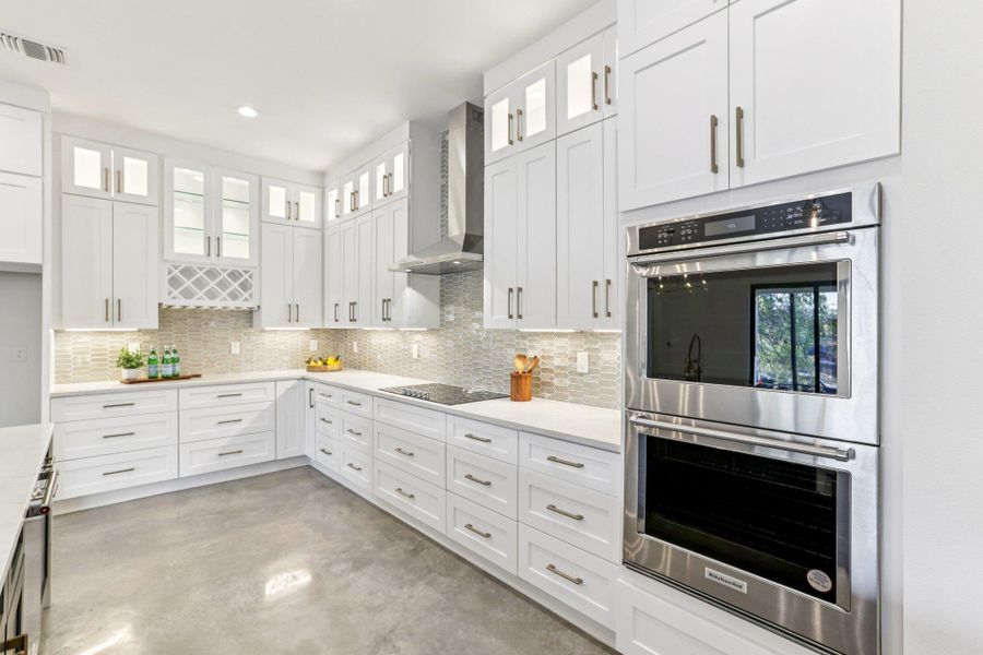 High-end design meets functionality with soft-close custom cabinetry. A built-in wine rack adds a touch of sophistication to your entertaining setup. The kitchen is fully equipped and ready for action with premium appliances.