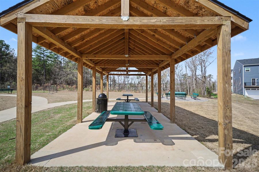 Community picnic pavilion with covered seating and walking paths