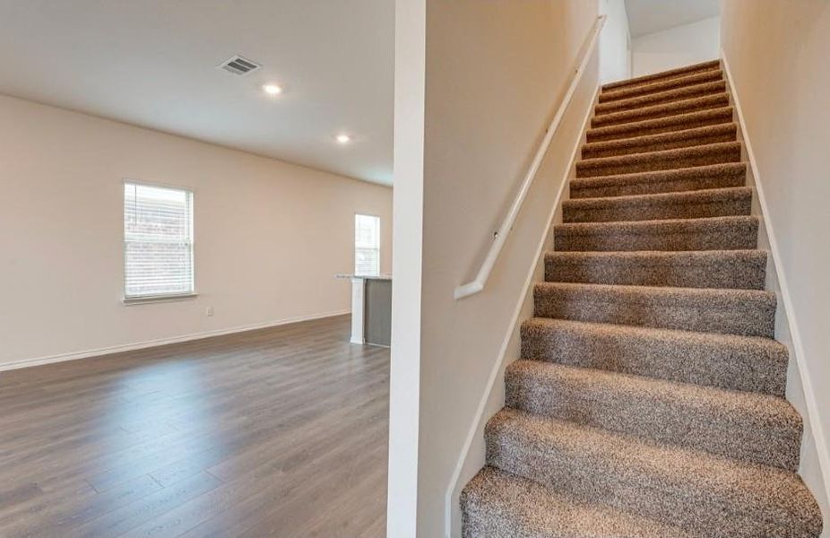Carpeted staircase with white handrail Carpeted staircase with white handrail