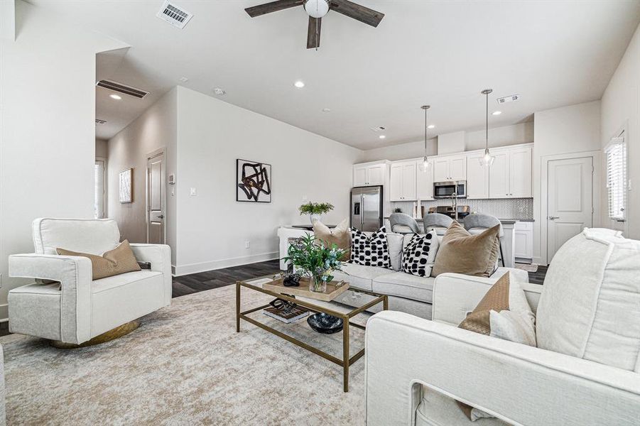 The open concept on the first floor seamlessly connects the living, diving and kitchen areas.