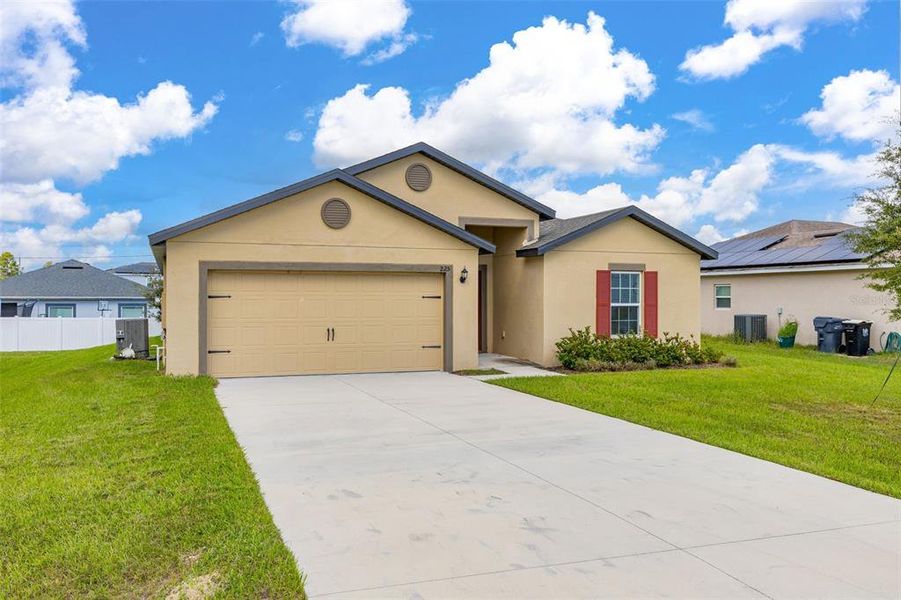 Front exterior of a new home in , Poinciana, FL, highlighting curb appeal (Image 1). Front exterior of a new home in , Poinciana, FL, highlighting curb appeal (Image 1).