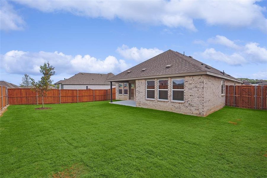 Back of property with a patio and a yard