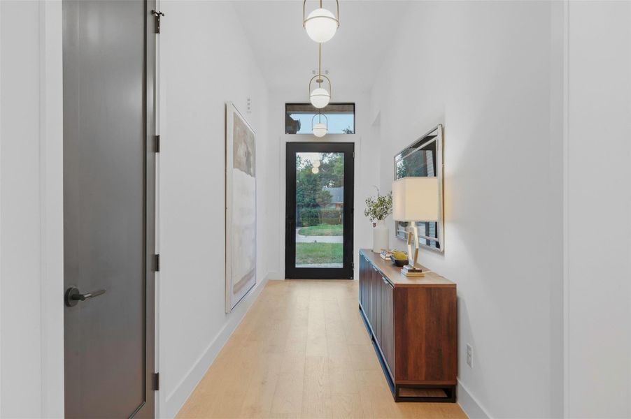 Light-filled entry welcomes you into a custom-designed interior with white oak finishes and elevated craftsmanship.
