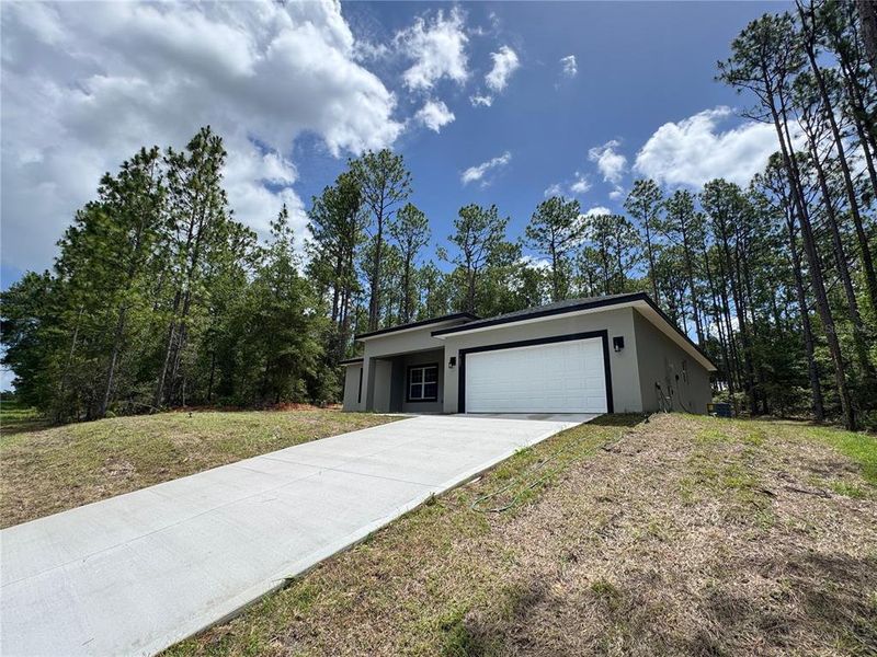 Front exterior of a new home in , Dunnellon, FL, highlighting curb appeal (Image 20).