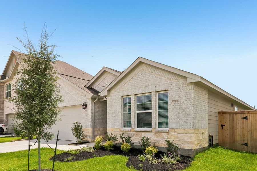 Front exterior of a new home in Riviera Pines - Classic Series, Huffman, TX, highlighting curb appeal (Image 2). Front exterior of a new home in Riviera Pines - Classic Series, Huffman, TX, highlighting curb appeal (Image 2).