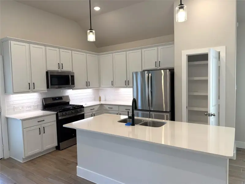 Light-filled kitchen with abundant lighting & under-cabinet illumination for the perfect ambiance!