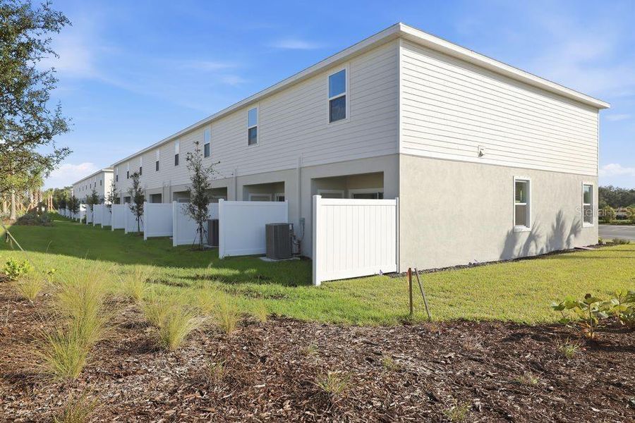 Exterior details and patio area of a home in The Towns at Firethorn, Parrish (Image 29).