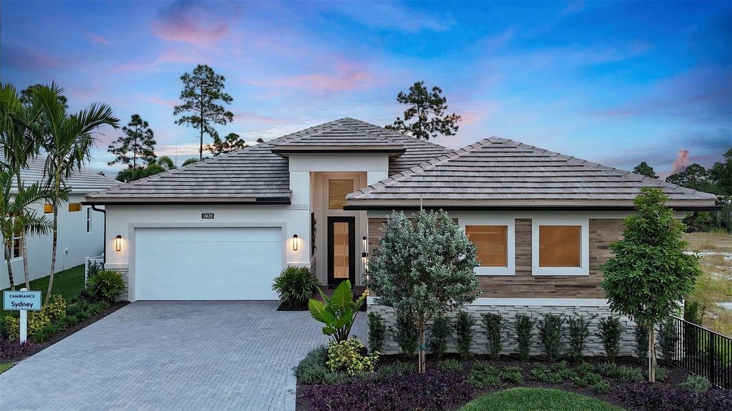 Front exterior of a new home in L'Ambiance at Avenir, Palm Beach Gardens, FL, highlighting curb appeal (Image 21).